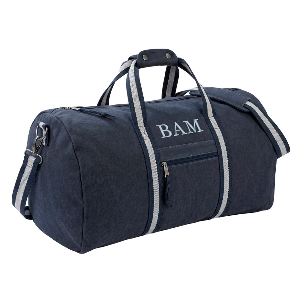 Bolsa de viaje azul marino con iniciales y correas de lona con asas de rayas.